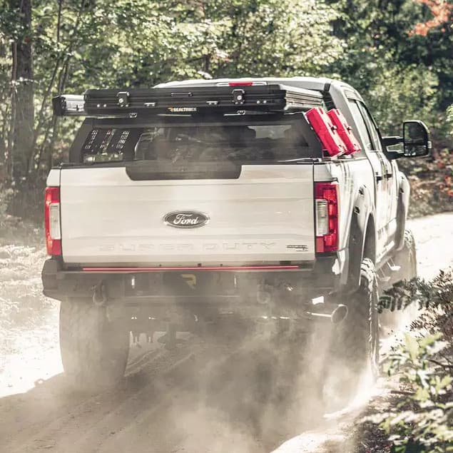 GoTent on back of truck driving through forest