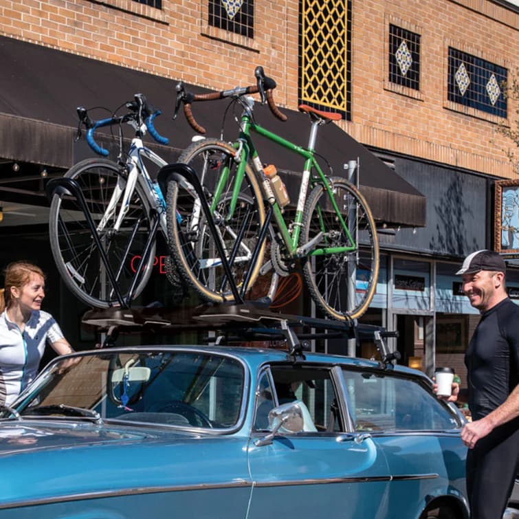 bike rack on car with people in town